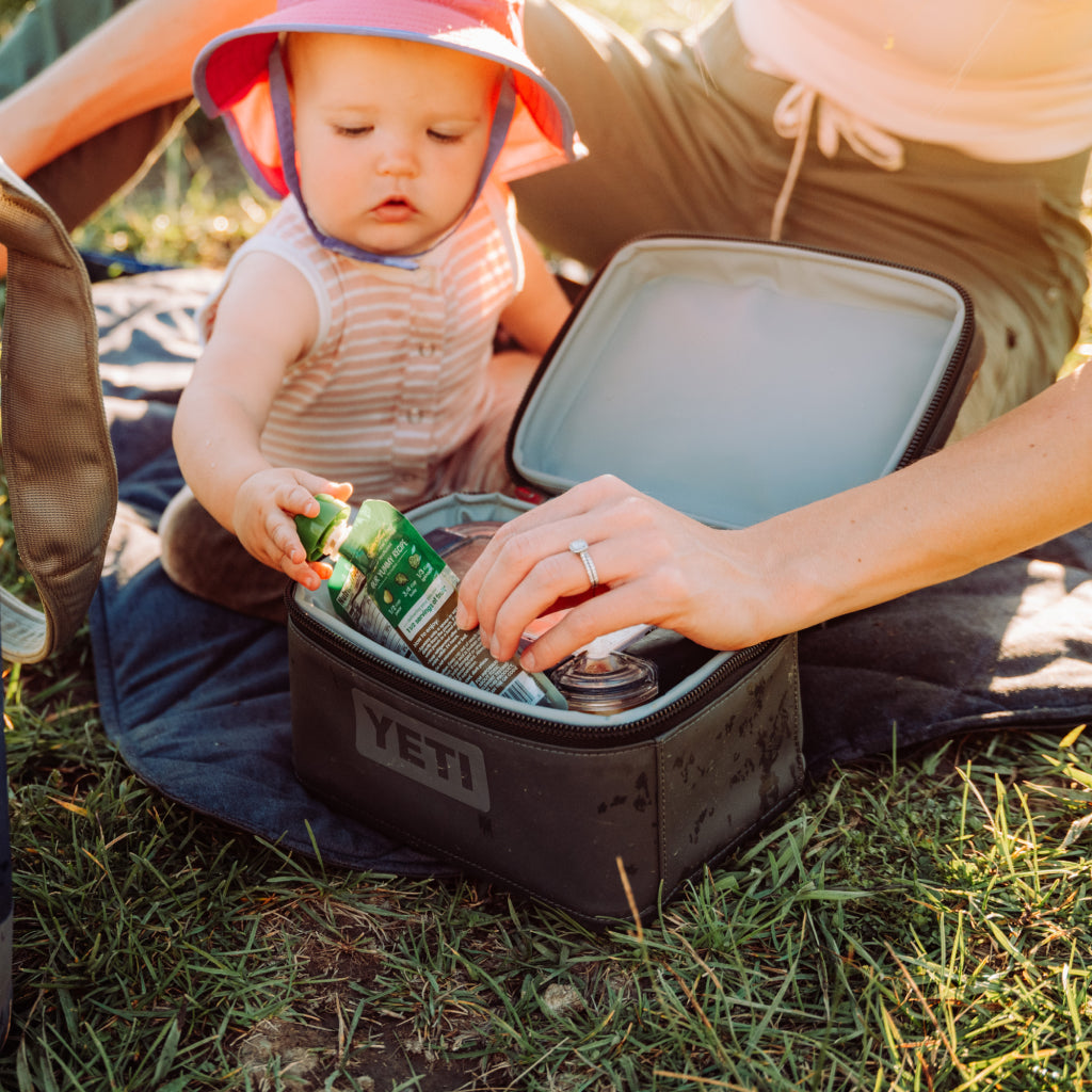 Person and child with a YETI cooler outdoors