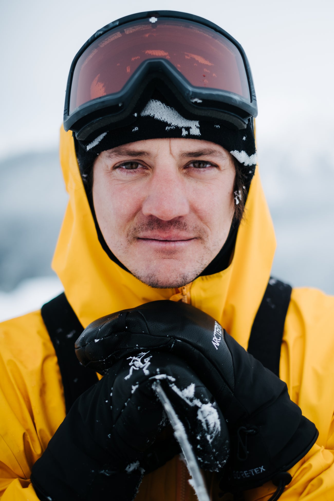 Victor Daviet wearing a yellow jacket and black goggles in a snowy landscape